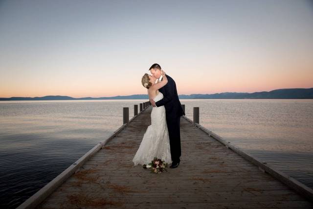 Newlyweds kissing on the dock