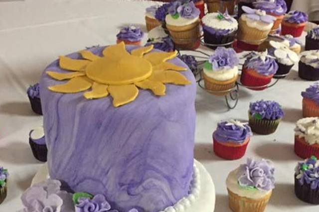 The bride loved the movie Tangled so this is the cake and cupcakes she ordered with the marble frosted top layer!