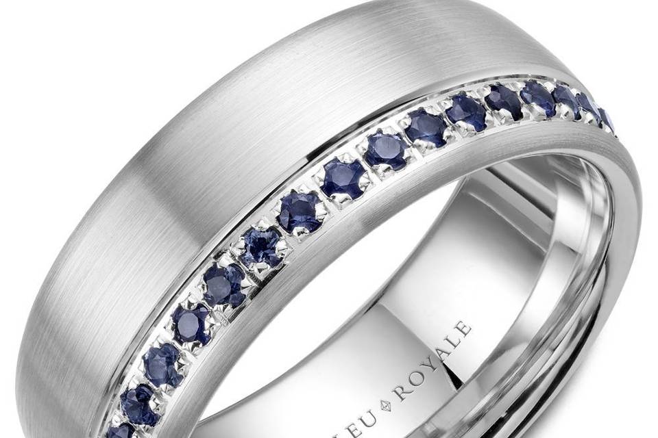 RYL-015WS85A Bleu Royale white gold wedding band with a brushed finish and 38 round blue sapphires.METAL: WhiteWIDTH: 8.5mmStone Setting: BezelStone Type: DiamondStone Shape: RoundNumber of stones: 38Clarity: Blue Sapphires AAATotal carat Weight: 0.87ct