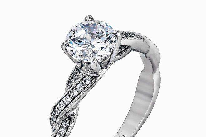 SIMON GMR1498This exquisite white contemporary engagement ring features a delicate twist design on the band accented by .22 ctw of sparkling round cut white diamonds.