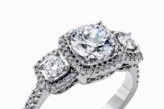 SIMON GMR2080This dramatic white gold engagement ring is set with .29 ctw of round cut white diamonds accentuated by .35 ctw of glimmering round cut side diamonds.