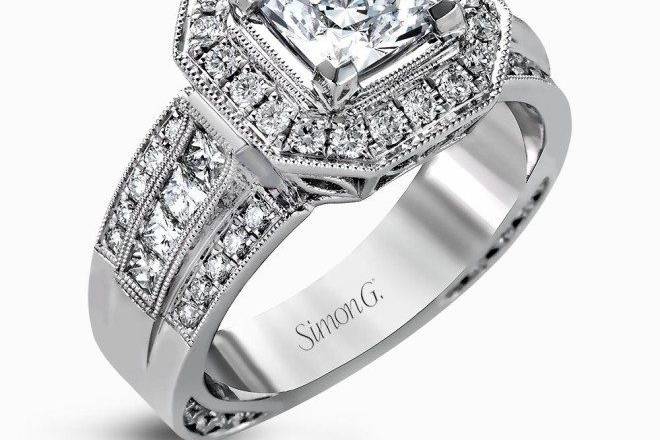 SIMON GNR109The dramatic contemporary design of this white gold ring is highlighted by .59 ctw of round cut white diamonds and .36 ctw princess cut diamonds.