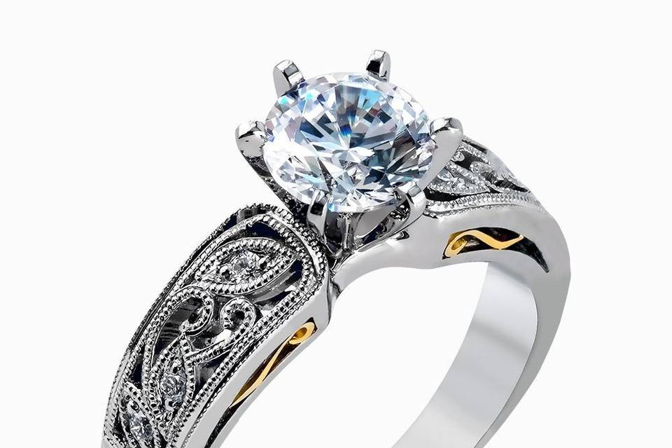 SIMON GLP1355This intricately designed white gold engagement ring features .07 ctw of exquisite round cut white diamonds, setting the stage for a stunning center stone.