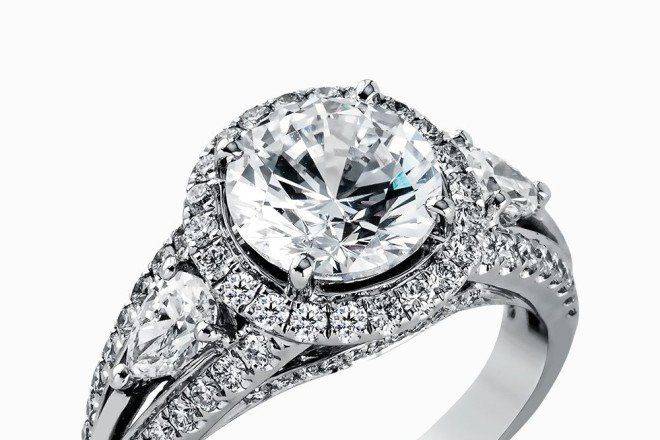SIMON GMR1503Reflecting a charming vintage design, this dazzling white gold engagement ring features .63 ctw of round cut white diamonds and .51 ctw of pear shaped white diamonds.
