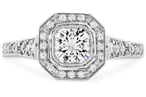 HEARTS ON FIREDECO CHIC DRM HALO ENGAGEMENT RINGThe Deco Chic Dream Engagement Ring includes a single Dream(square shaped) solitatire diamond and surrounded by a halo of smaller diamonds, giving the illusion of a larger diamond. The thin delicate band of diamonds adds that little extra sparkle.