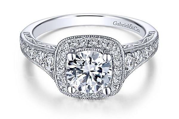 GABRIEL & COFLORENCEUnique and intricate scrollwork beneath the center stone is what makes this 14k white gold diamond engagement ring special. Decadent diamonds within the channels of the band evokes sophisticated beauty.