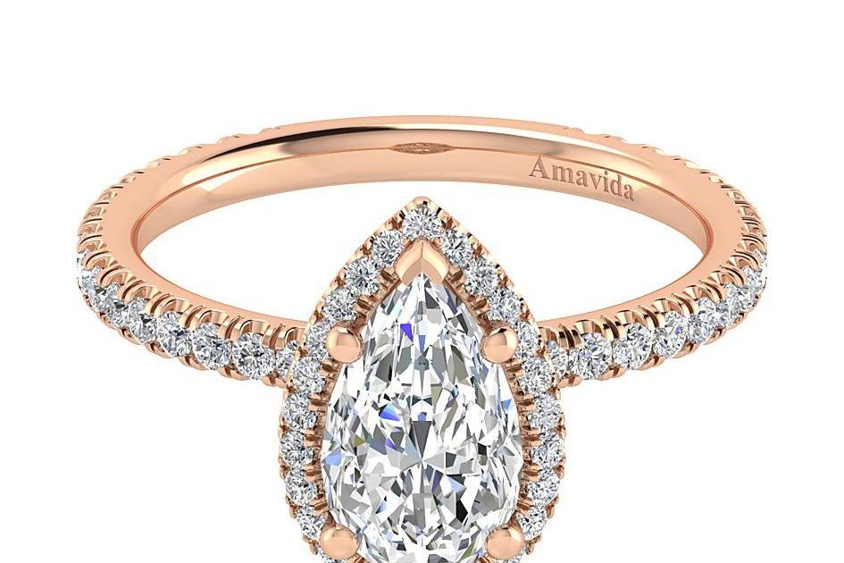 GABRIEL & CODAFFODILSimple and feminine, this pear shaped engagement ring includes a sparkling diamond halo encircling the center stone and a row of sparkling pave diamonds adorning the delicate band.