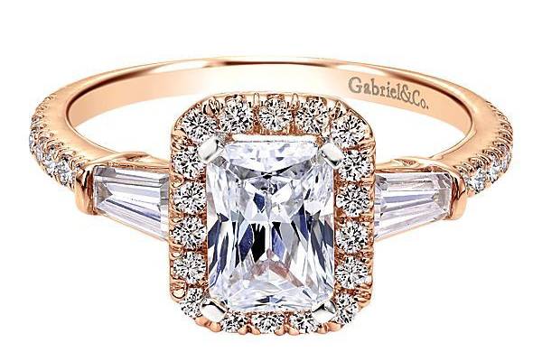 GABRIEL & COLARKINA striking emerald cut center stone is the focal point as the detailed halo and graceful diamond baguette accent stones accentuate the center stone.