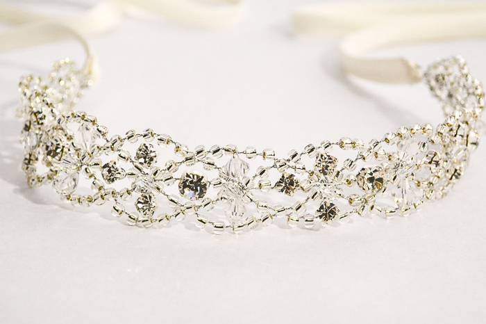 Encrusted with crystals and rhinestones, this lattice work sash is woven with delicate bead detailing and finished with trailing ribbons. Airy and beautiful, our sashes may be worn as a bridal headpiece or wedding belt.