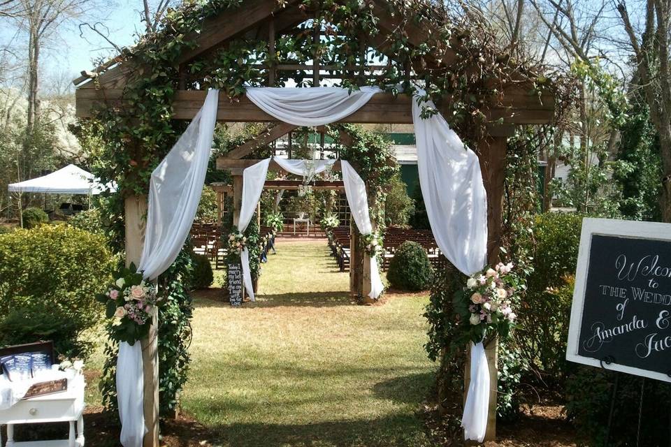 Two arbors leading to the pergola in the Wedding Garden at the Brady Inn, Madison GA.