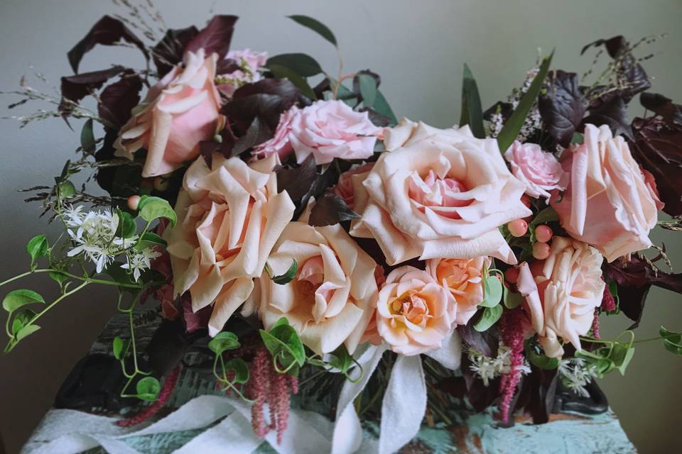 Romantic peach & blush garden style bouquet with super ruffly roses and vine tendrils