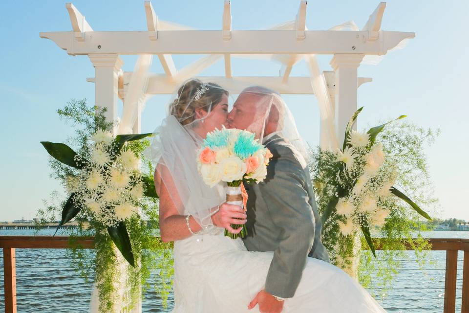 Couple kiss at wedding cabana