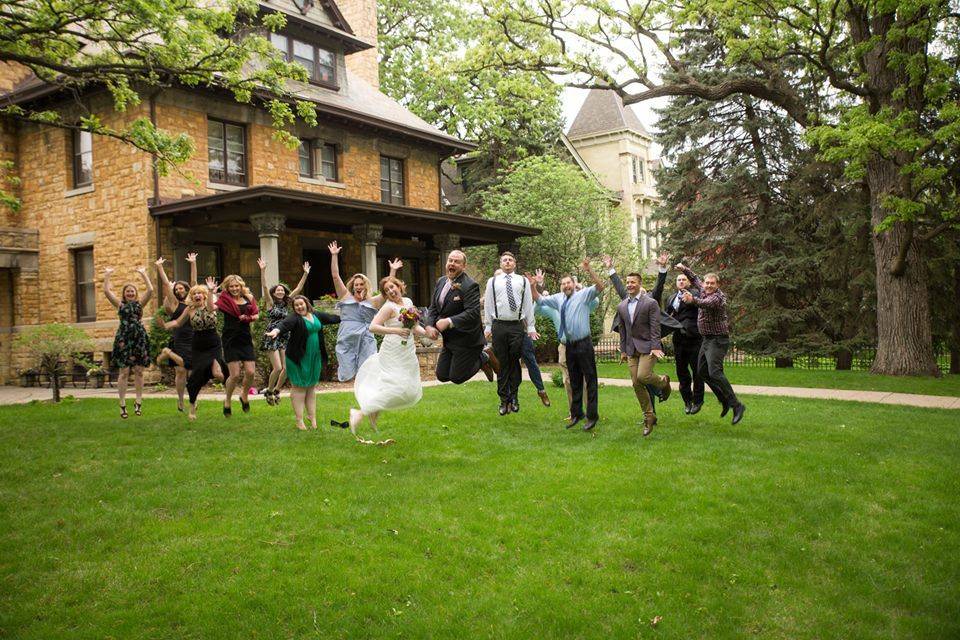 Jump shot of newlyweds and entourage