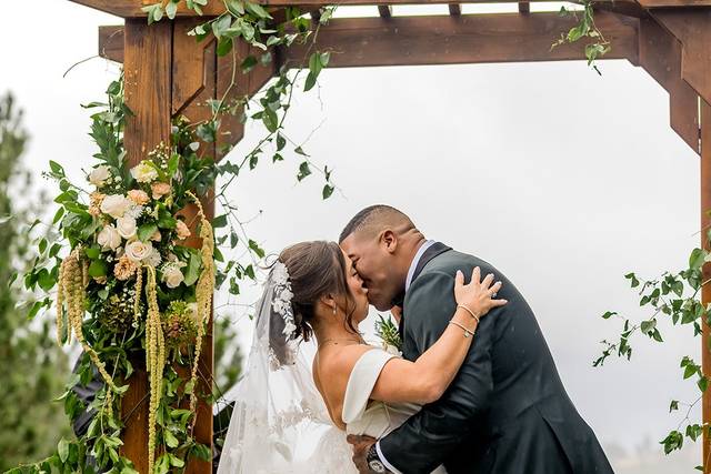 Couple under wedding arbor