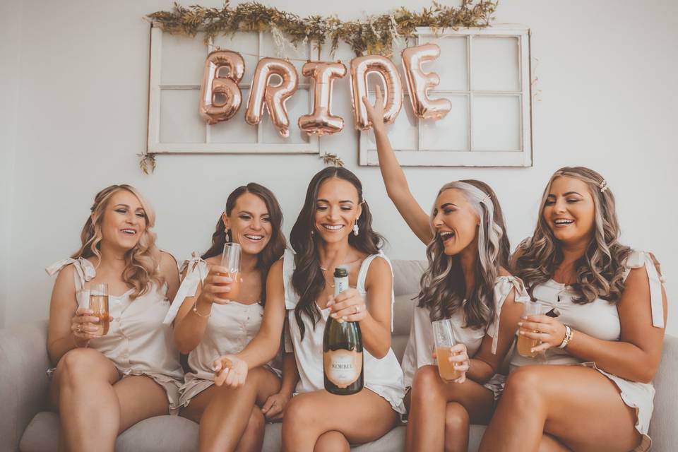 Bridesmaids Popping Champagne