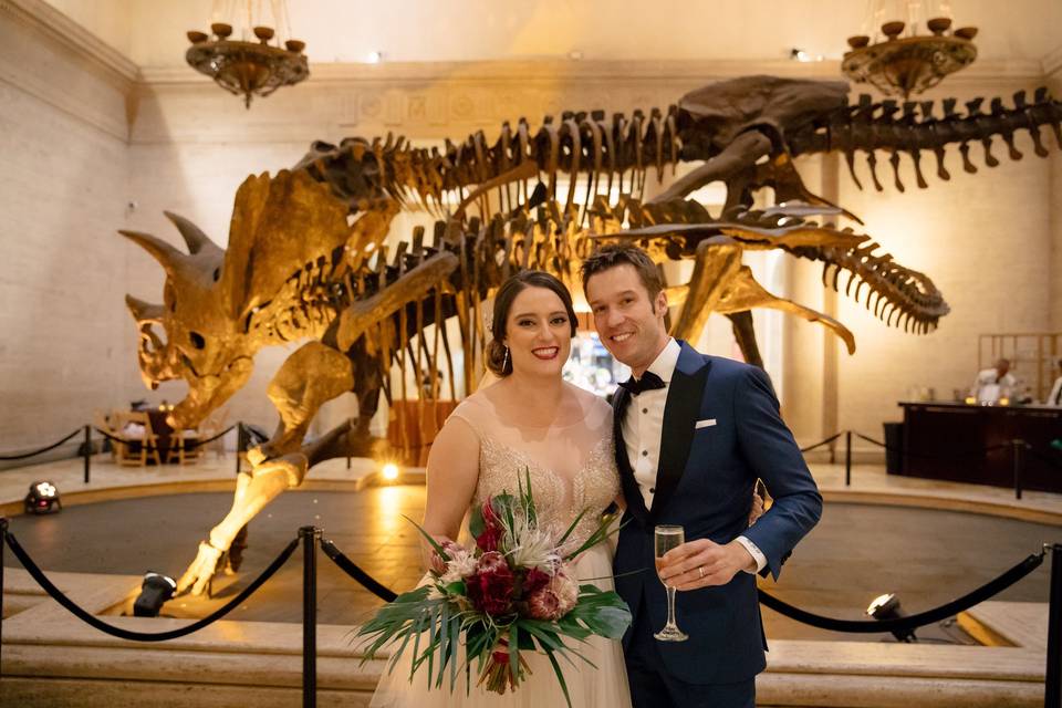 Newlyweds by the dinosaur skeleton