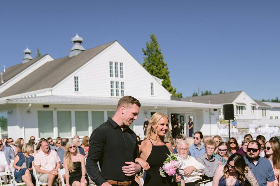 Groom and bridesmaid walking