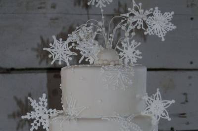Royal Icing Snowflakes adorn a rolled fondant cake.