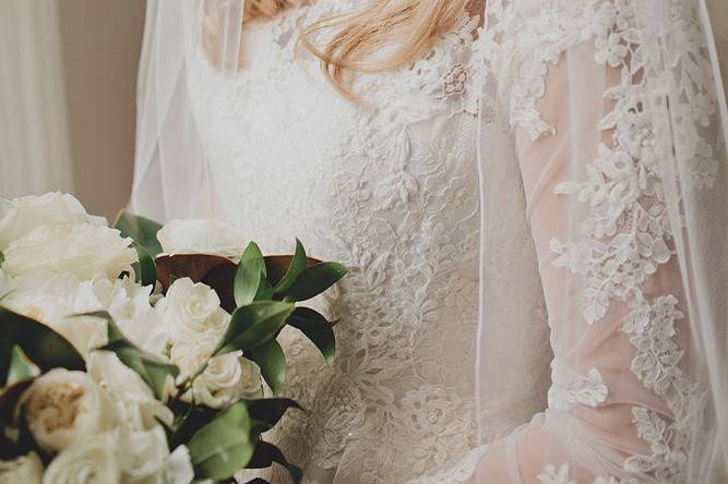 Bride in sleeved lace wedding dress