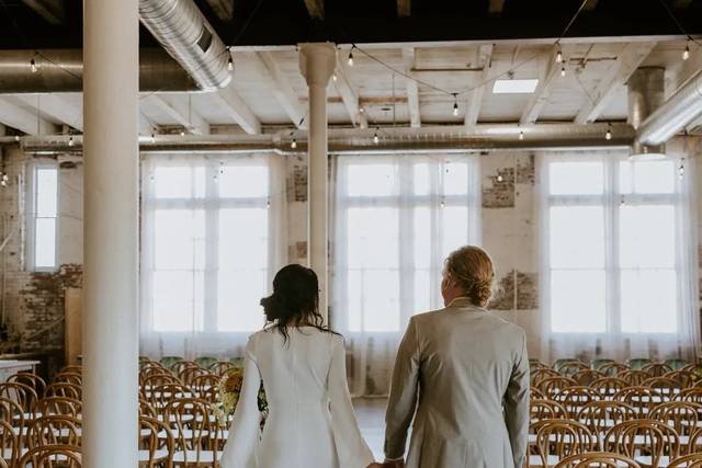 Newlyweds walking the ceremony aisle