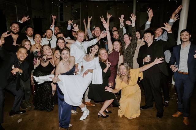 Guests toasting under string lights