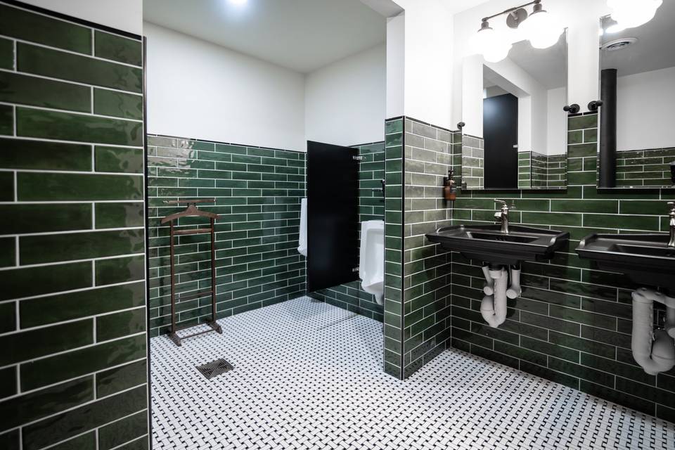 Restroom with green subway tile