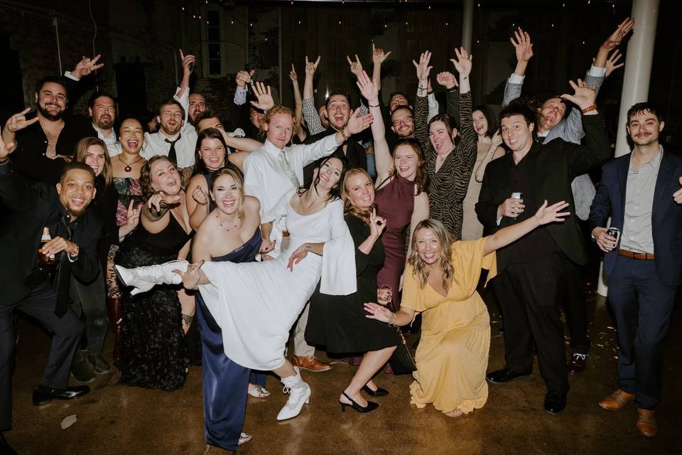 Guests toasting under string lights