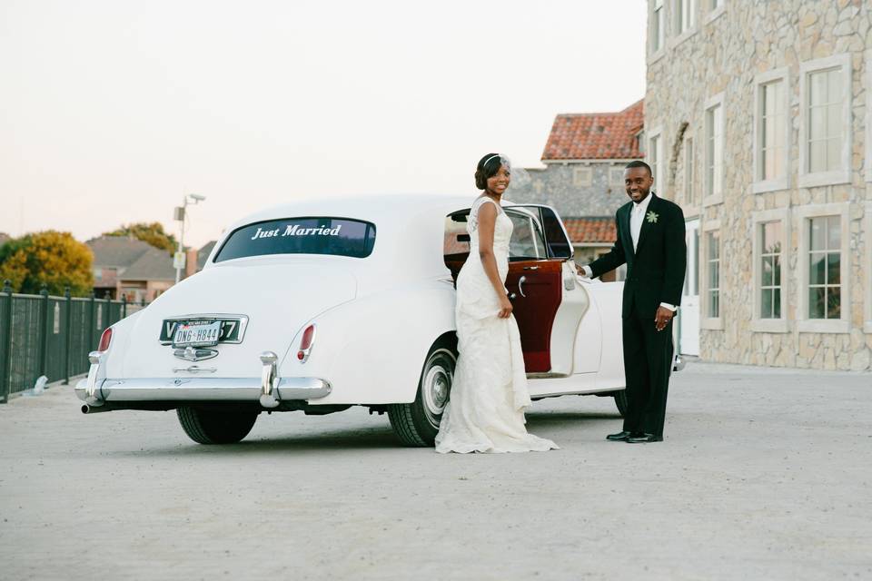 Couple and their wedding car