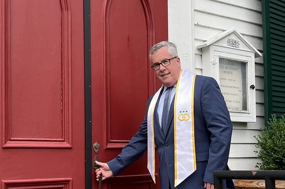 Cogan entering Church