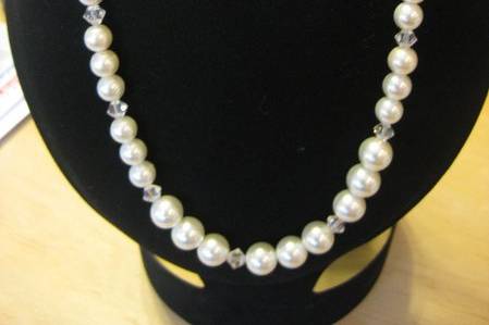 A little sparkle to the classic pearl necklace. Made with 10mm Swarovski white pearls and clear Swarovski accents and boosts a magnet closure. Earrings are on sterling silver wires. Gold-tone available also.