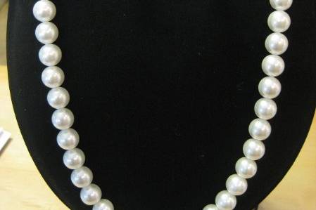 Timeless and elegant 10mm white Swarovski pearl necklace with magnet closure for easy on and off. Single pearl drop earrings on sterling silver wires. Pearls offered in many colors. Gold-tone is also available.