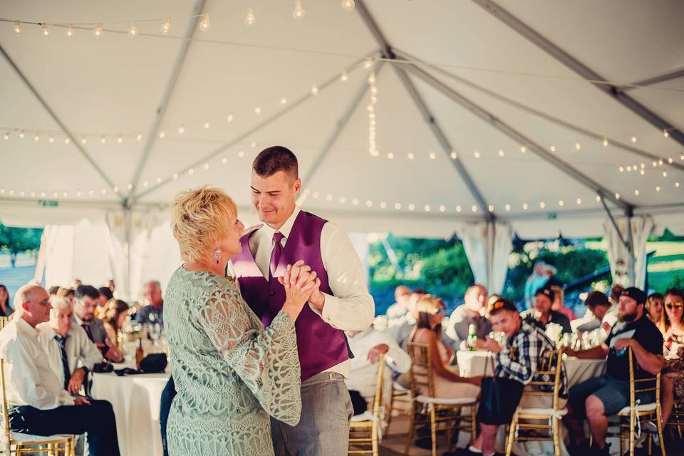 The groom and her mother dancing