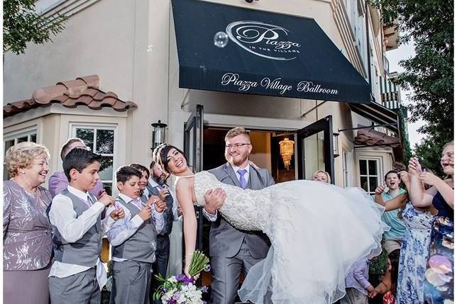 Groom lifting his bride