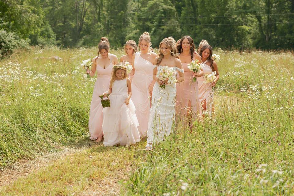 Bridal party walk in flowers