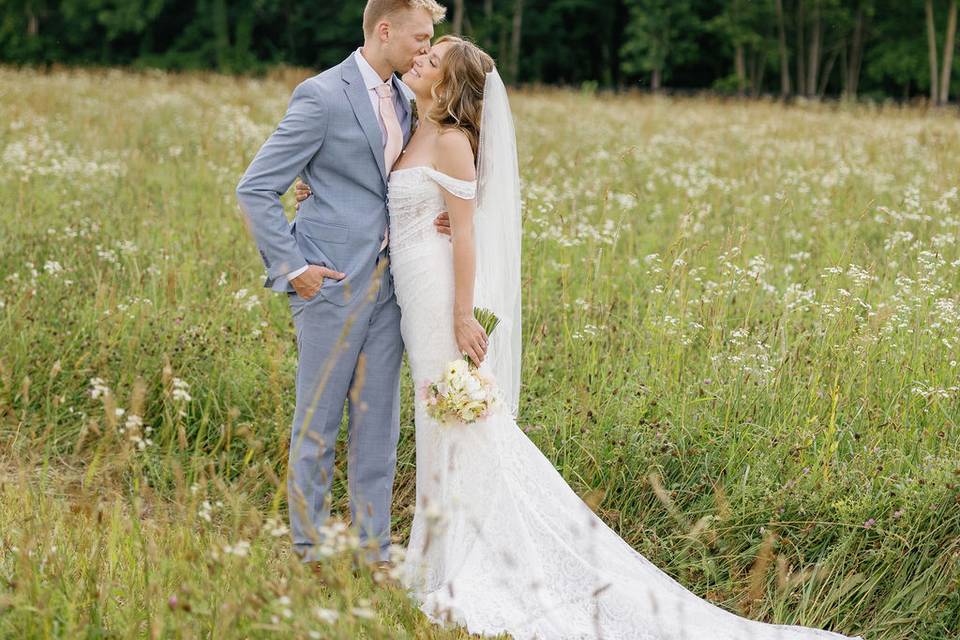 Bride & groom in wildflowers