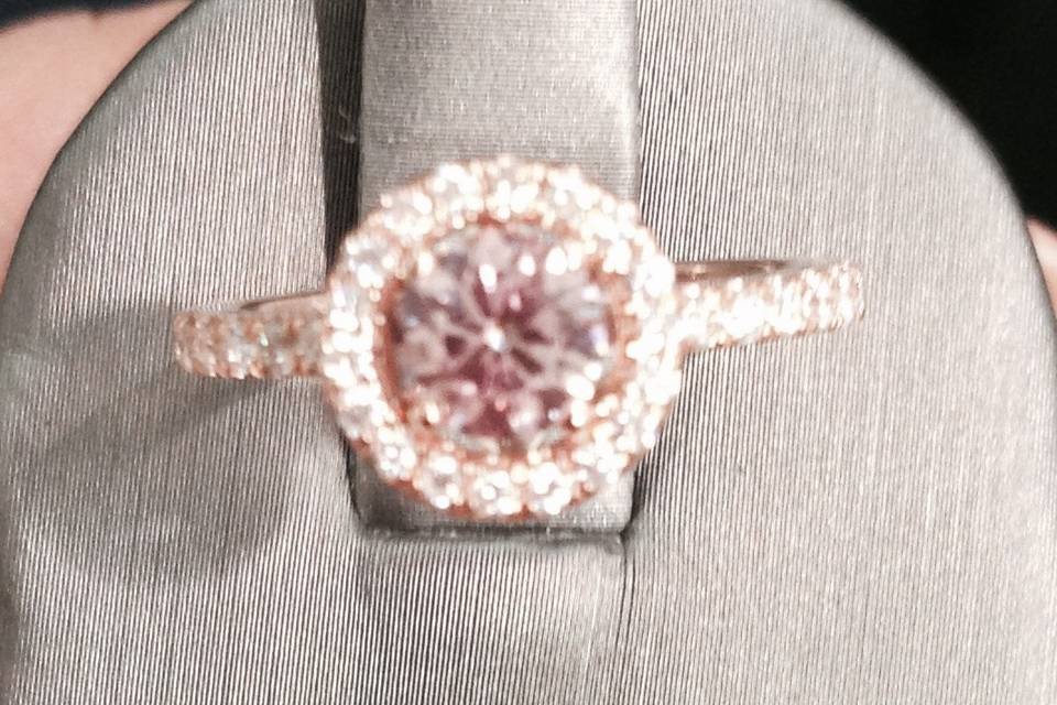 A rose gold band casts a warm glow over a glamorous pink diamond center stone.
18K Rose Gold