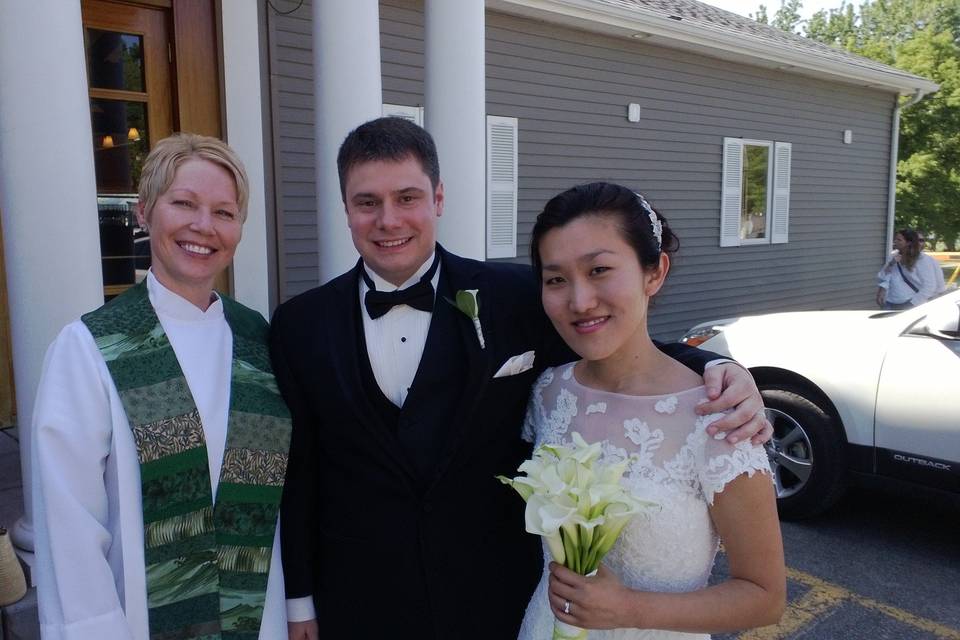 Newlywed couple and the officiant