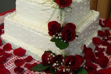 This is a 3 tier, White Almond Sour Cream Cake with Buttercream Frosting.  Fresh roses were placed into the cake along with along side it.