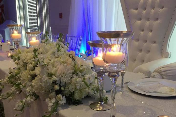 Candlelit head table and floral decor
