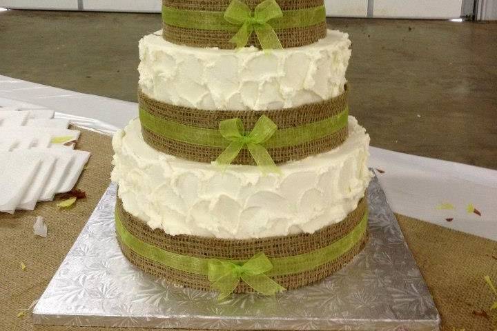 3-tier wedding cake with green ribbons