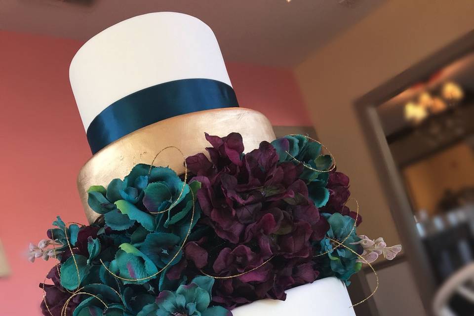 Wedding cake with blue ribbons and flowers