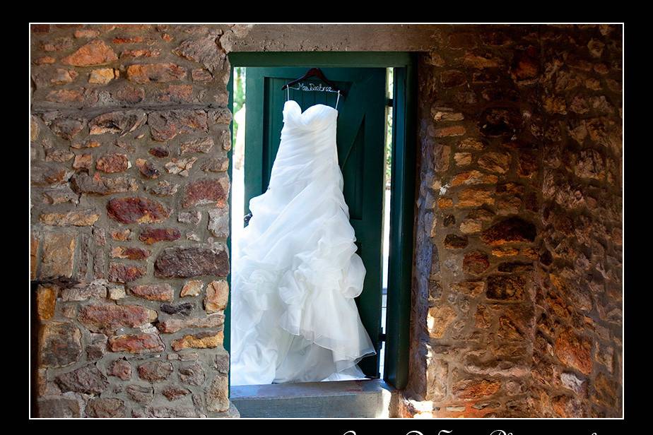 Megan's dress hangs in the beautiful historic barn at Holly Hedge Estate. Photography by Cindy DeSau.