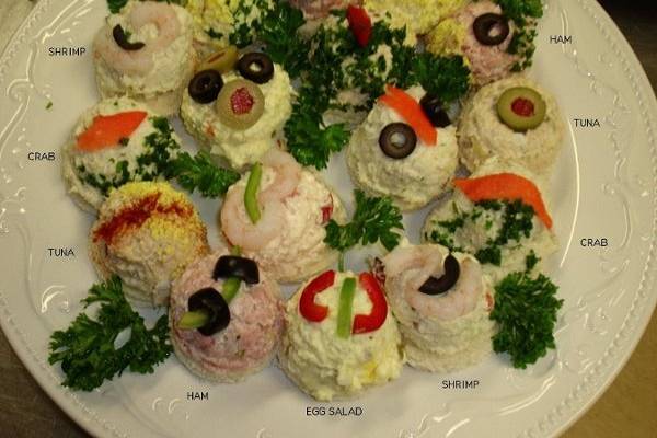 This delightful, open-faced and individually decorated finger sandwich assortment includes crap, shrimp, ham, tuna and egg.  The perfect passed hors d'oeuvre