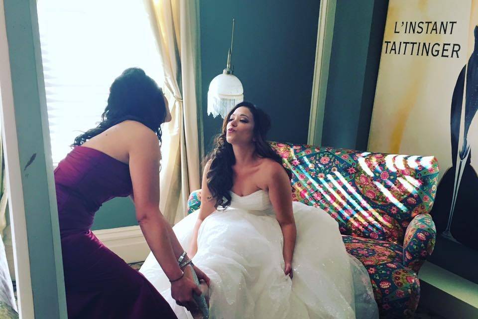 Behind the scenes photo of bride and maid of honor