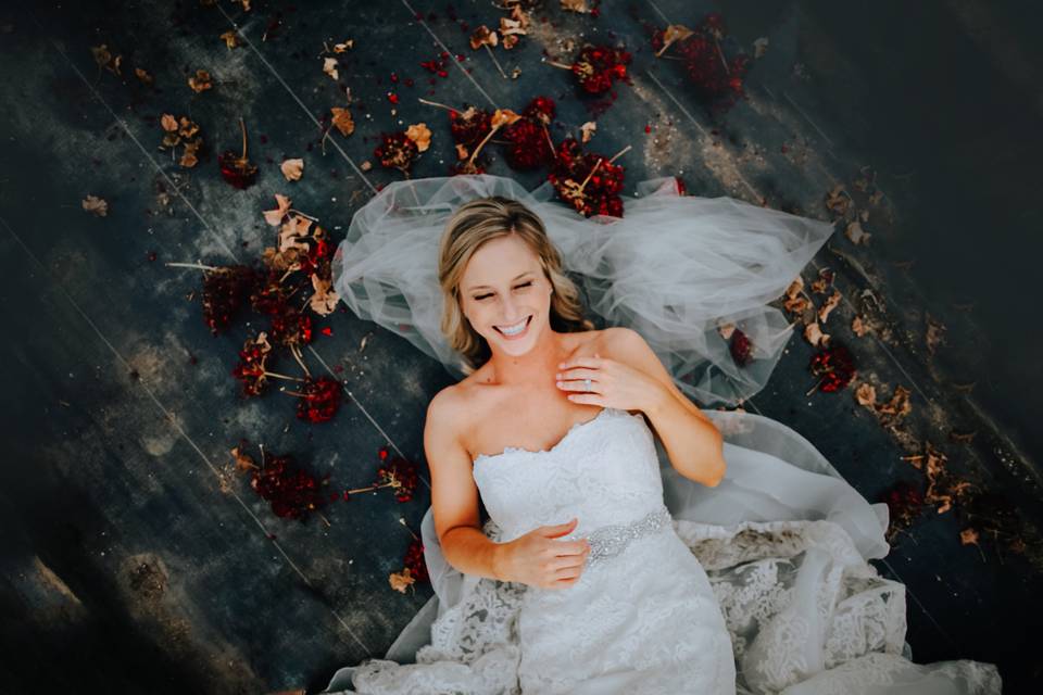 Bride laying in flowers