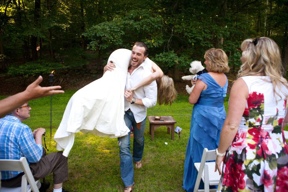 This groom did something quite unexpected at the end of their ceremony.  He literally scooped his bride into his arms and carried her off.  None of us expected it—it was fun!