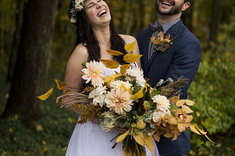 Newlyweds kissing outside the barn