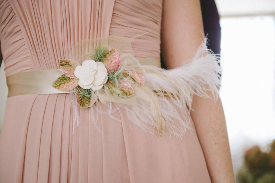 Bridal sash with ostrich feather and succulents. Photo by Nathan Russell Photo.