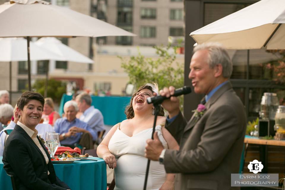 Brides laughing at wedding speech on the Rooftop Terrace