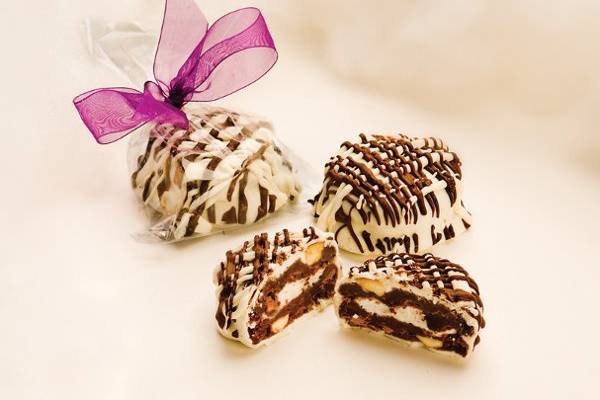 Rock-A-Mallow Wedding Cookie Favors: Imagine yourself eating the perfect cookie, double dark and semi sweet chocolates, infused with soft, fluffy marshmallows and roasted almonds, then completely immersed in white chocolate with dark chocolate drizzle... yummmmmm.
http://www.heidisheavenlycookies.com/products/Heavenly_Rock_A_Mallow_Cello_Bags-62-29.html